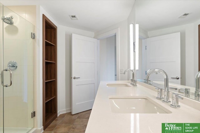 bathroom featuring a shower with shower door and vanity