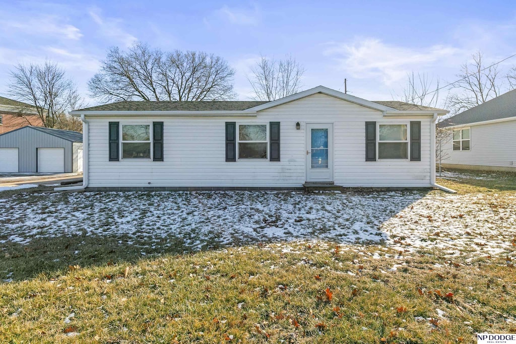 single story home with a garage and an outbuilding