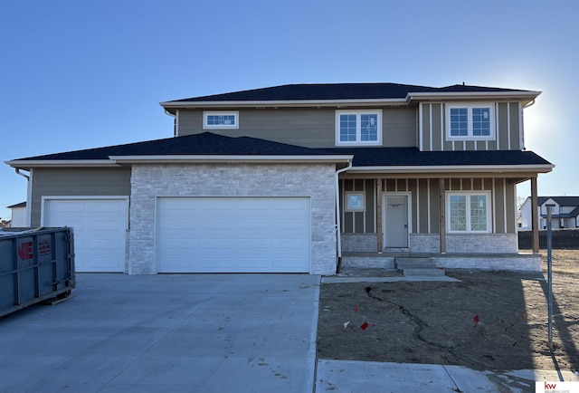 view of front of home featuring covered porch and a garage