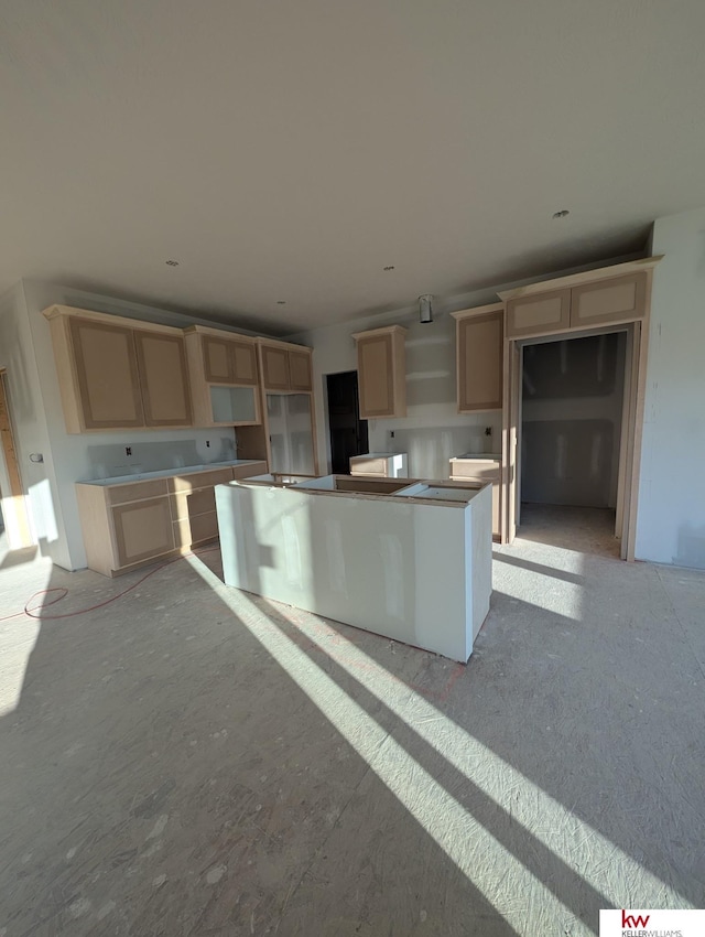 kitchen featuring a center island and light brown cabinets