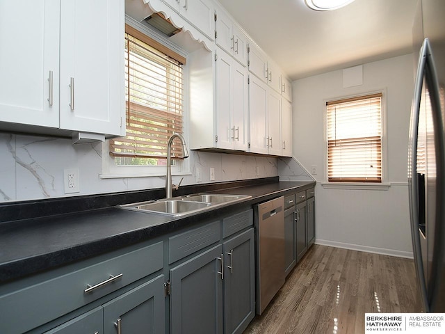 kitchen featuring white cabinetry, hardwood / wood-style floors, dishwasher, fridge with ice dispenser, and sink