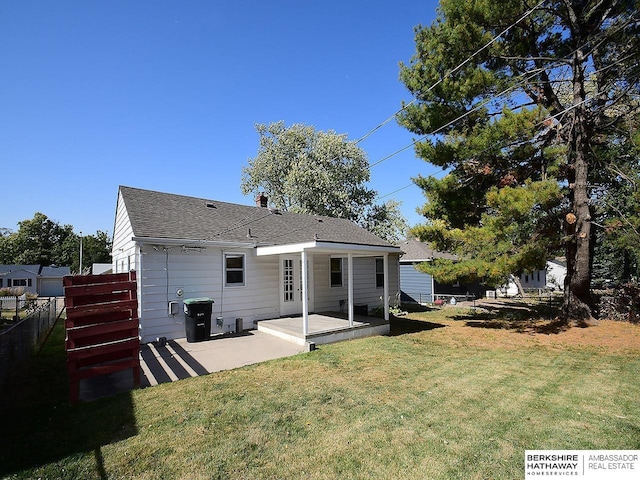 rear view of property with a patio area and a lawn