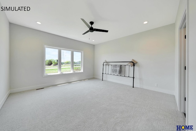 unfurnished bedroom with ceiling fan and light colored carpet