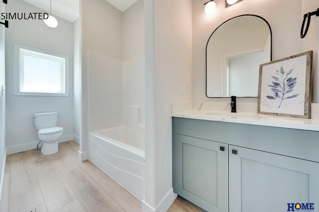 bathroom featuring toilet, hardwood / wood-style flooring, and vanity