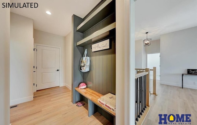 mudroom with light hardwood / wood-style flooring and a notable chandelier