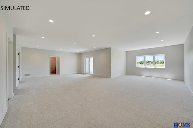 spare room featuring light colored carpet