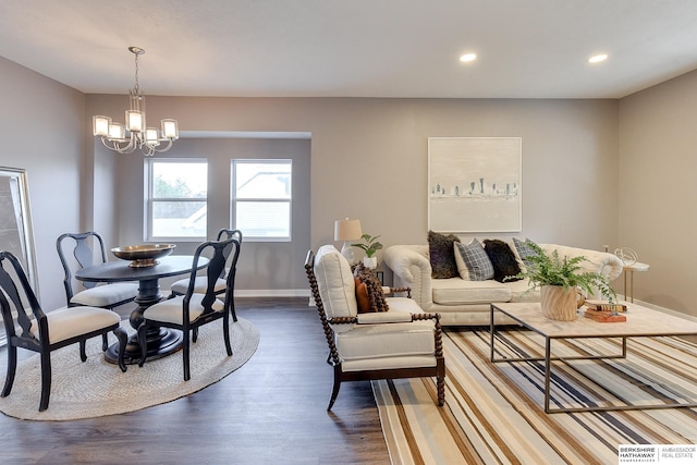 living room with dark wood-type flooring and an inviting chandelier