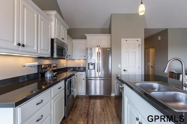 kitchen featuring pendant lighting, sink, white cabinetry, appliances with stainless steel finishes, and dark hardwood / wood-style flooring