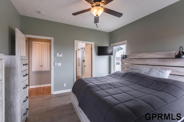 bedroom featuring ceiling fan, dark wood-type flooring, and connected bathroom