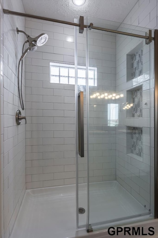 bathroom with a shower with shower door