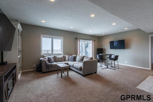 living room with a textured ceiling and carpet flooring