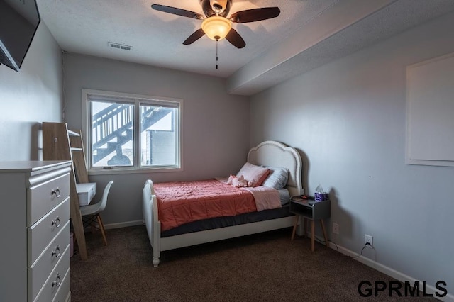 bedroom featuring ceiling fan and dark carpet