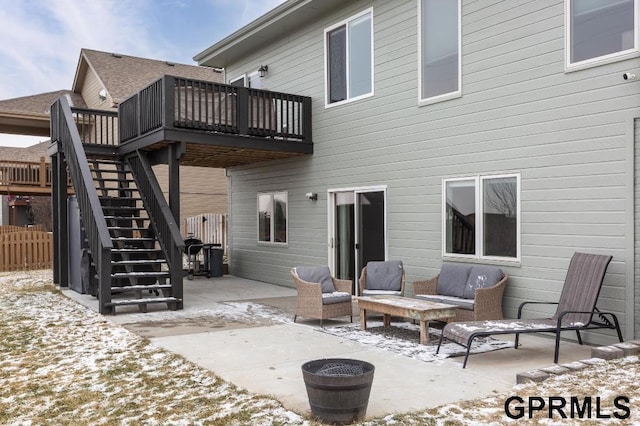 snow covered property with a deck and a patio area