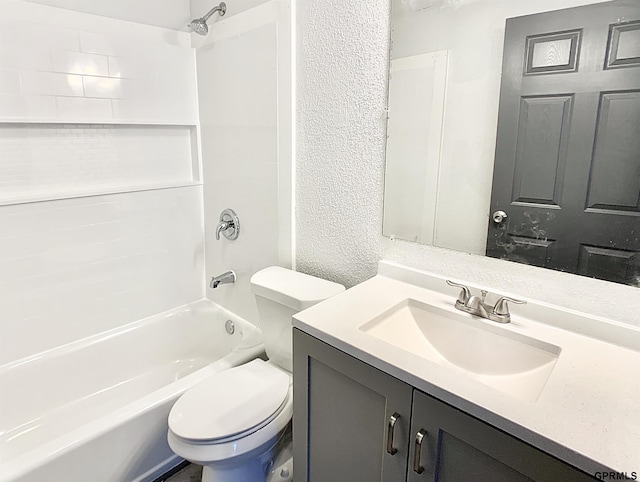 full bathroom with toilet, vanity, and shower / washtub combination