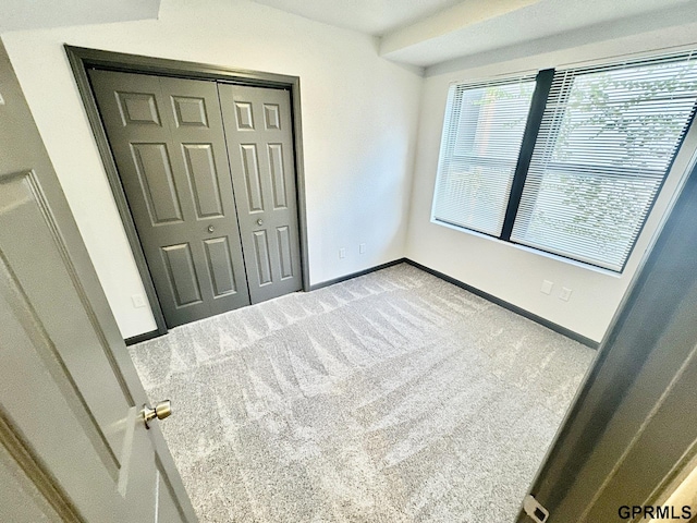 carpeted bedroom with a closet