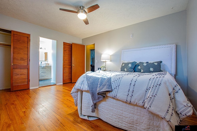 bedroom with a textured ceiling, hardwood / wood-style floors, connected bathroom, a closet, and ceiling fan