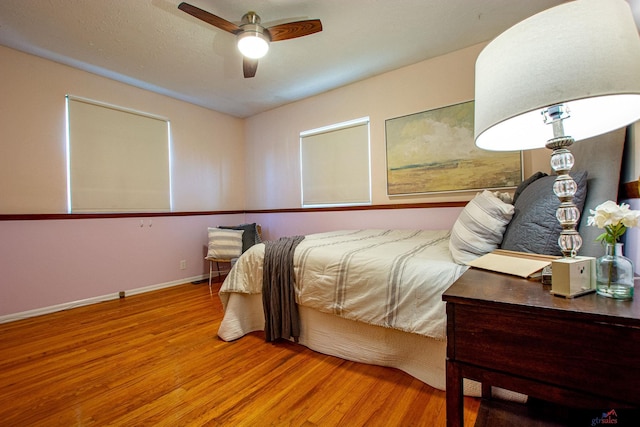 bedroom with ceiling fan and wood-type flooring