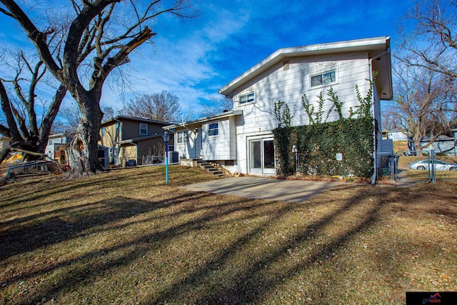 back of house featuring a patio area, a yard, and central AC unit