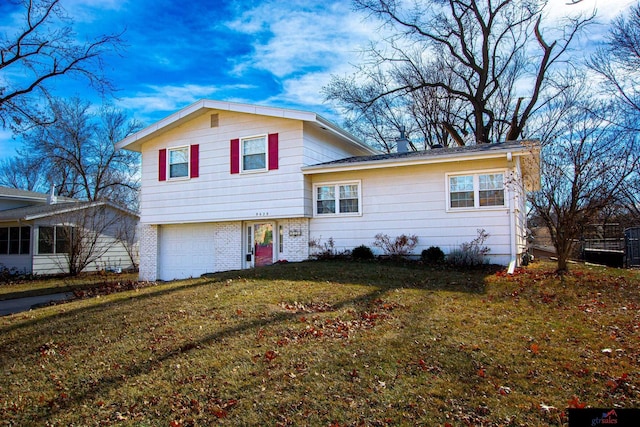 tri-level home with a front lawn and a garage