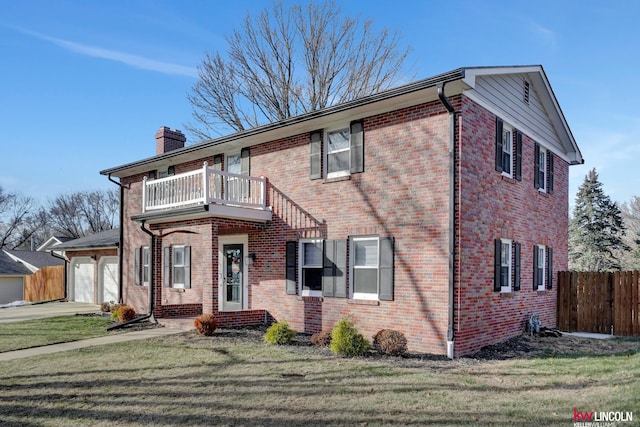 view of front of house with a front lawn, a garage, and a balcony