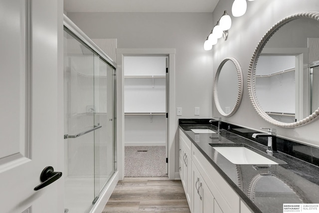 bathroom featuring vanity, hardwood / wood-style floors, and walk in shower