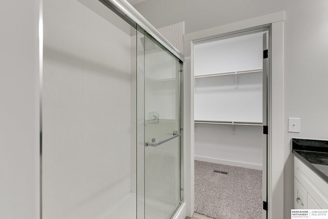 bathroom with vanity and walk in shower