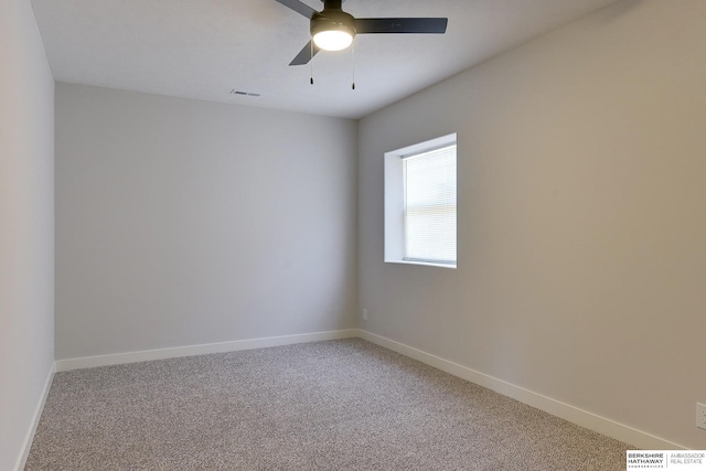 empty room with ceiling fan and carpet flooring