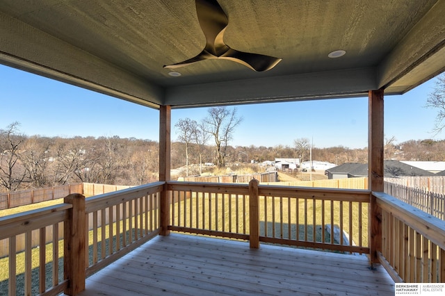 wooden deck featuring ceiling fan and a yard