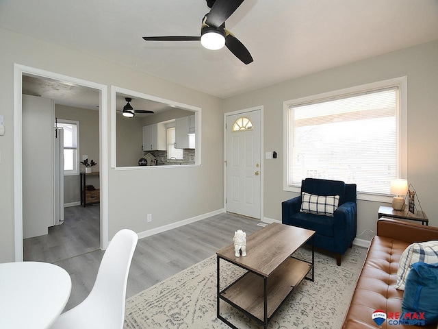 living room featuring light hardwood / wood-style floors and ceiling fan