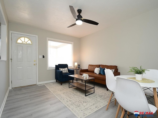 living room with ceiling fan and light wood-type flooring