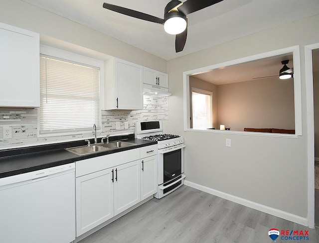 kitchen with white appliances, white cabinets, and tasteful backsplash