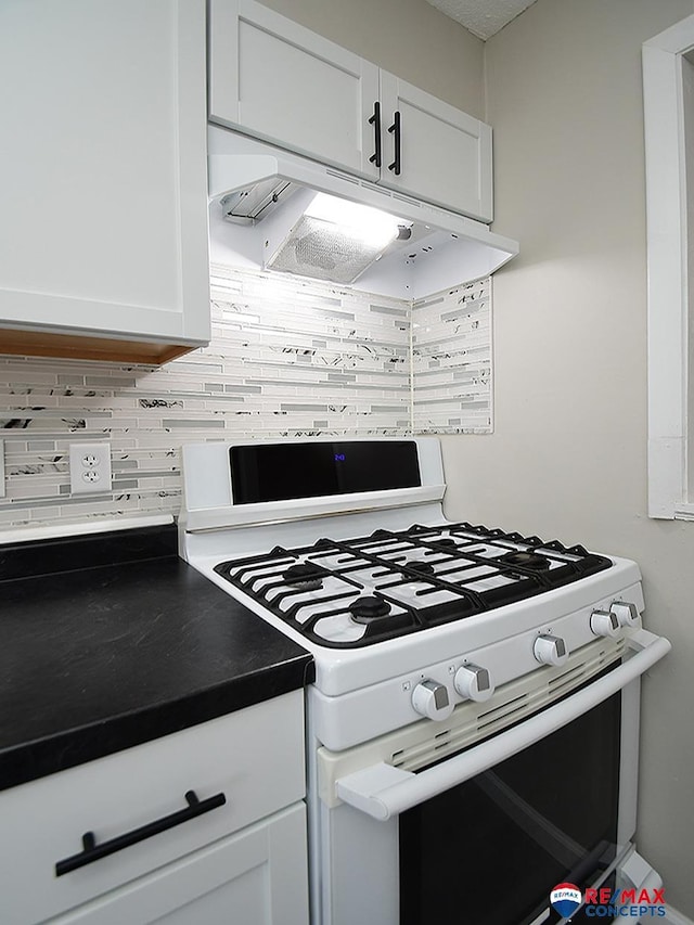 kitchen with white range with gas cooktop, white cabinetry, and tasteful backsplash