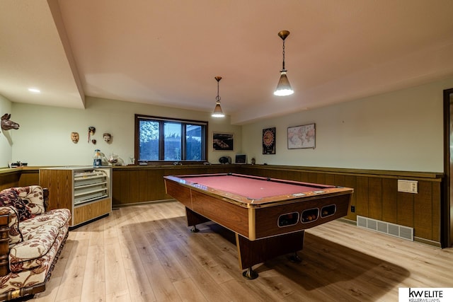 game room with billiards, wood walls, and light wood-type flooring