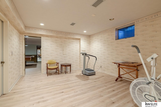 exercise area with light wood-type flooring