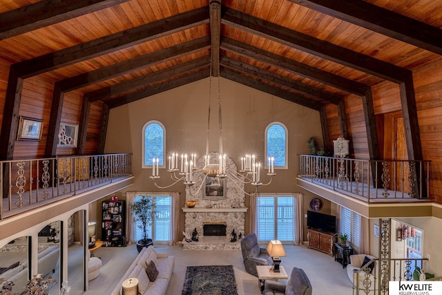 carpeted living room featuring high vaulted ceiling, beam ceiling, a notable chandelier, and a fireplace