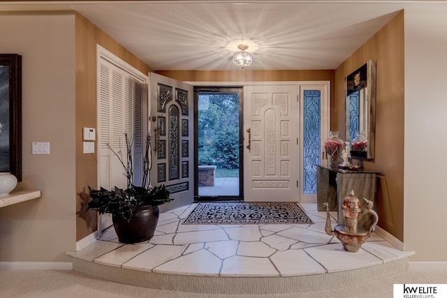 entryway with wood walls