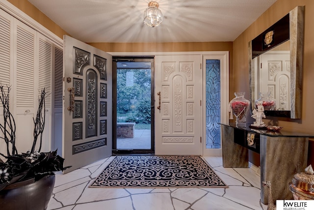 entryway featuring a textured ceiling