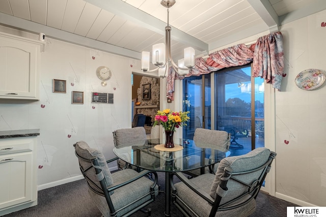 carpeted dining room with beam ceiling, a fireplace, an inviting chandelier, and wooden ceiling