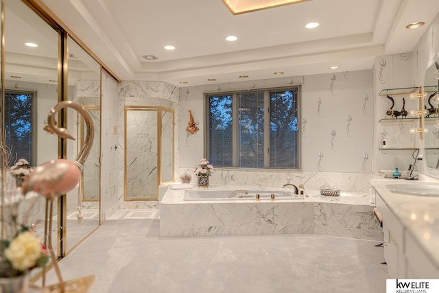 bathroom featuring vanity, a raised ceiling, and independent shower and bath