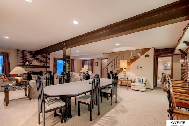 carpeted dining room featuring a brick fireplace and beamed ceiling