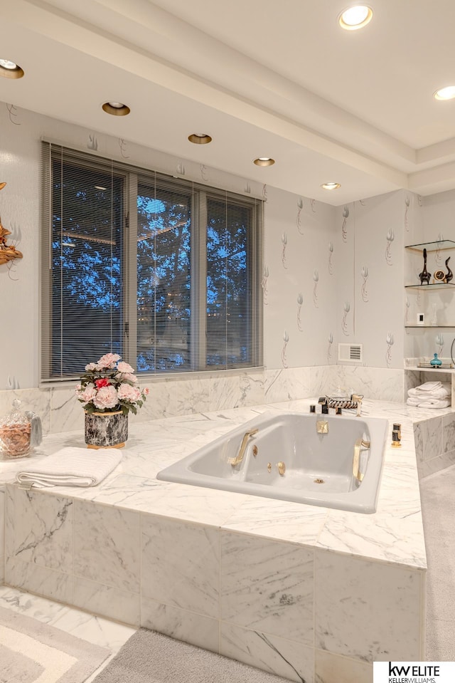 bathroom featuring tiled tub