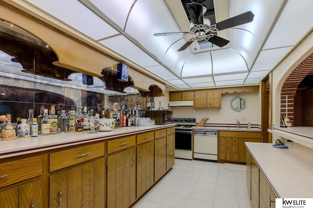 kitchen featuring ceiling fan, sink, white appliances, and light tile patterned floors