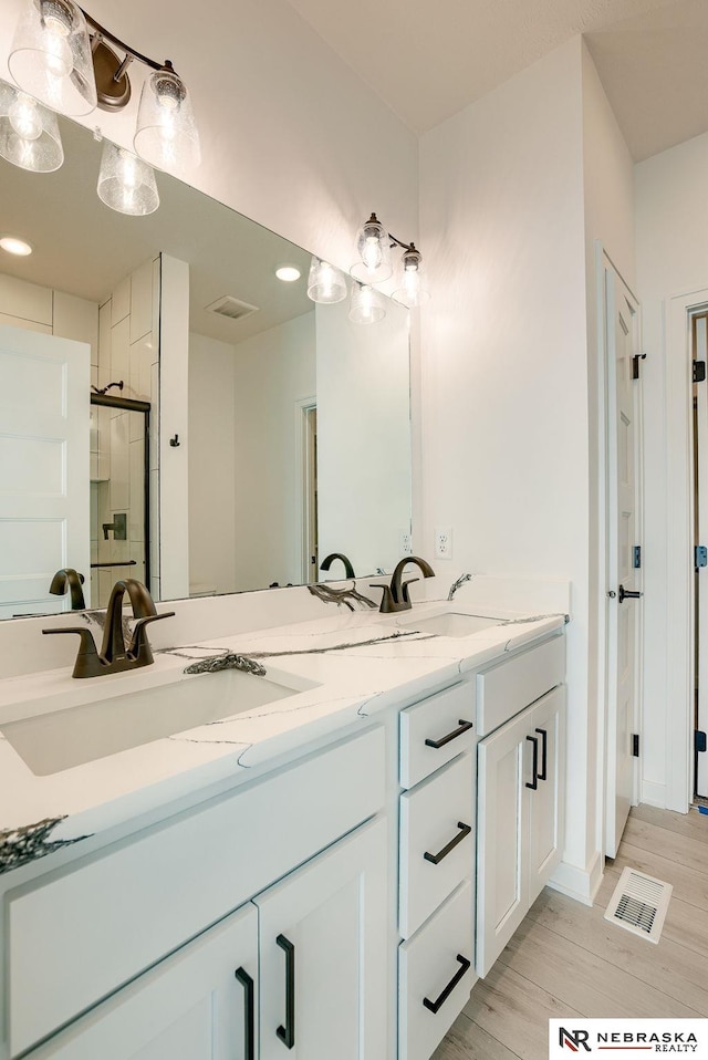 bathroom with walk in shower and vanity