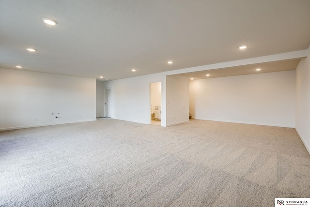 unfurnished room featuring light carpet