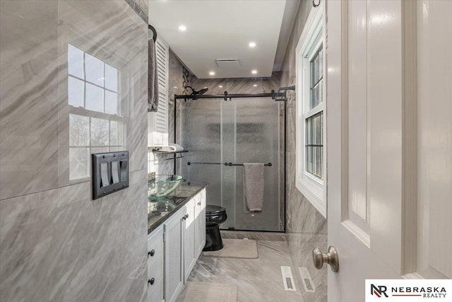 bathroom featuring an enclosed shower, vanity, and toilet