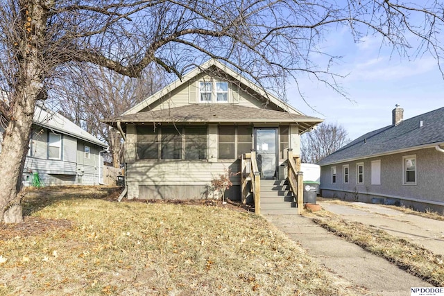 bungalow-style home featuring a front yard