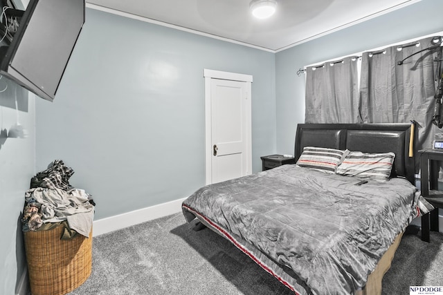 bedroom with dark colored carpet, ornamental molding, and ceiling fan