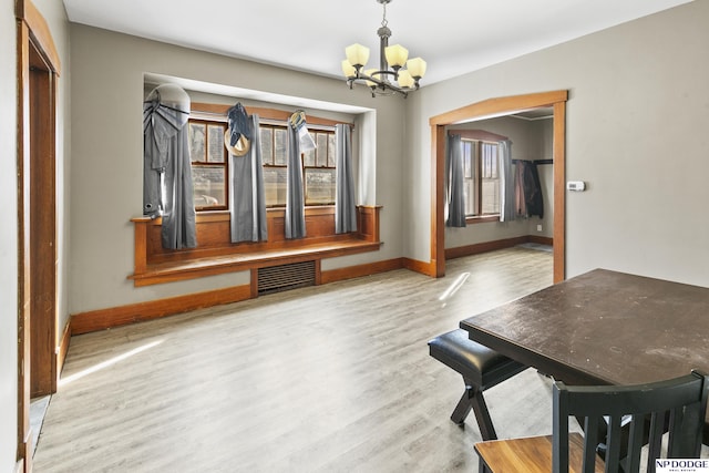 unfurnished dining area featuring wood-type flooring and a chandelier