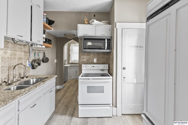 kitchen featuring white cabinetry, decorative backsplash, white range with electric cooktop, and sink