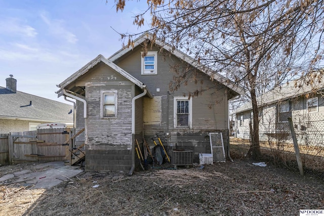 rear view of property with central air condition unit